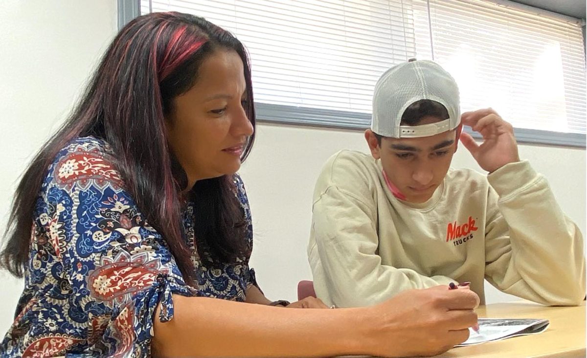 Raquel Cunha helps student Eduardo Romero in class. Cunha is the director of the ESL department (English as a Second Language) at Campbellsville University.