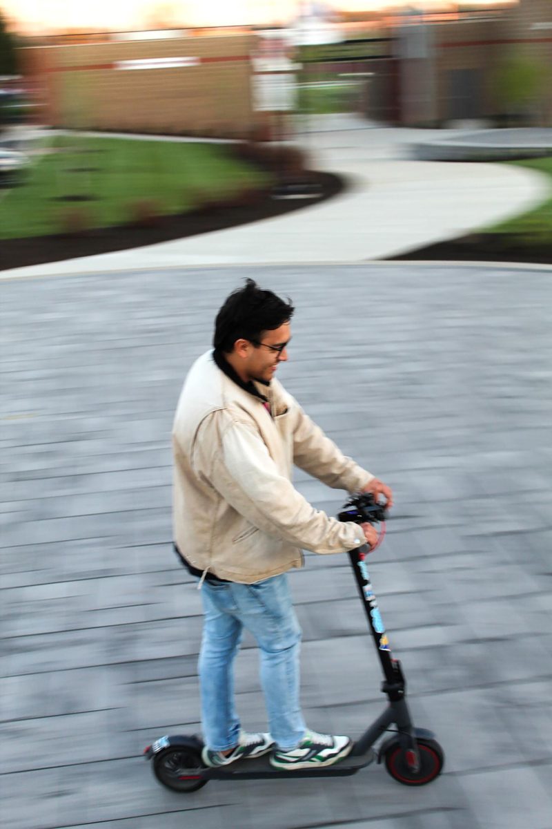 Ian Lopez rides his scooter across campus. He mainly uses this $250 investment to travel to the mass communication building and to events he works on campus. “I just scoot around,” Lopez said. “That’s the way I get around.” 