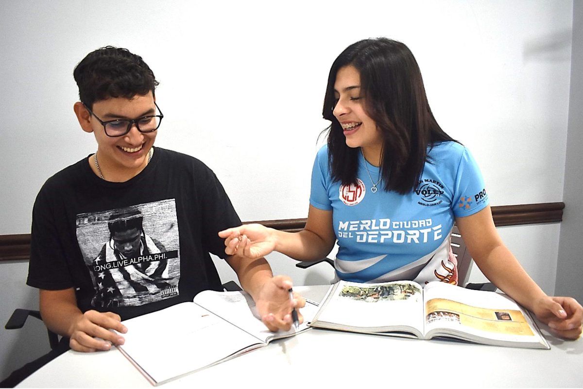 Oscar Gonzales and Camila Rossi have some fun while doing their homework in their ESL class.
