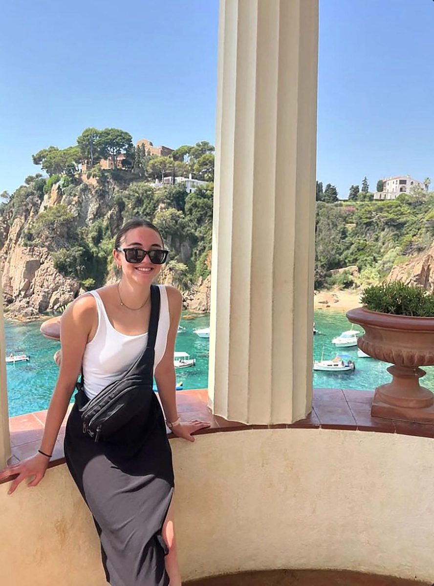 Ellie Eisses sits among the Spanish architecture overlooking a lake during her journey to Segovia, Spain. (Photo provided)