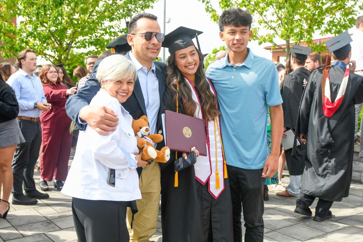 Oriana Espinoza, second from right, poses with her family following her commencement. From left are Yajaira Mendoza (Espinoza’s mother); Frank Espinoza (Espinoza’s father); Espinoza; and Jesus Espinoza (Espinoza’s brother). Espinoza, of Cornelius, N.C., received a Bachelor of Science in Mass Communication Area. (Photo by Gerard Flanagan/Office of Marketing and Communications)
