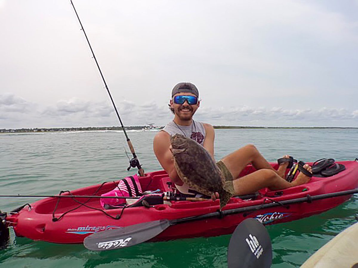Peyton Hughes shows off a fish he caught while vacationing in North Carolina with his girlfriend, Amy Wathen.