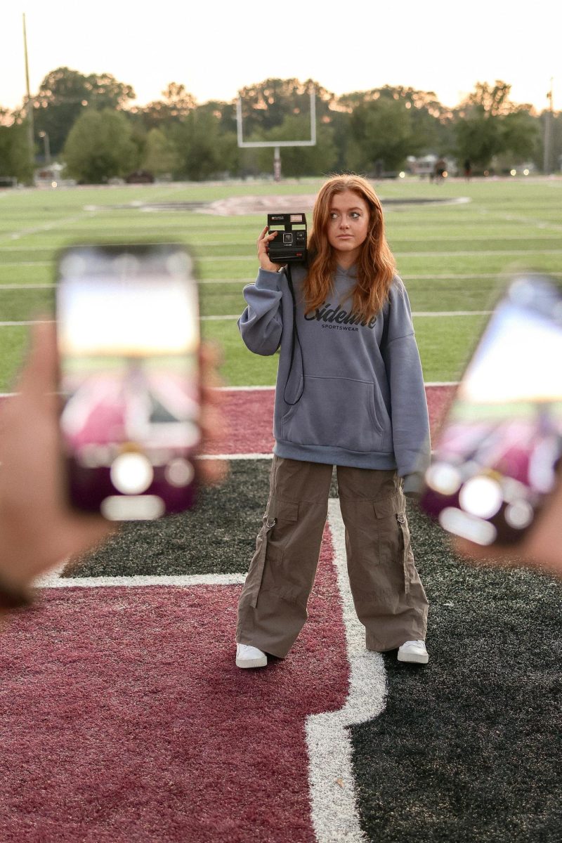 Cathryn Jones, Campbellsville Alumni and founder of Sideline Sportswear, stands on the field wearing one of her own designs. Inspired by her love for sports, media and fashion, Jones created the brand to give creators and fans alike something stylish to wear on the sidelines. (Photo by Seth Manley)