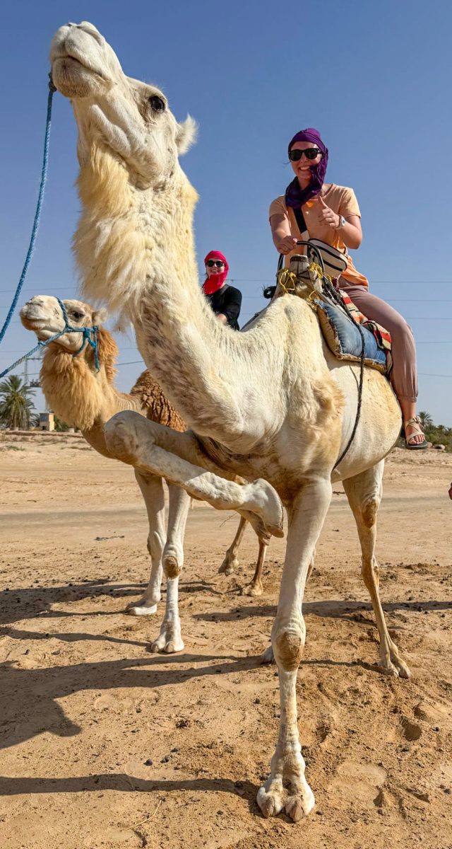 Macy Brown rides a camel during one of the team's weekend outings.