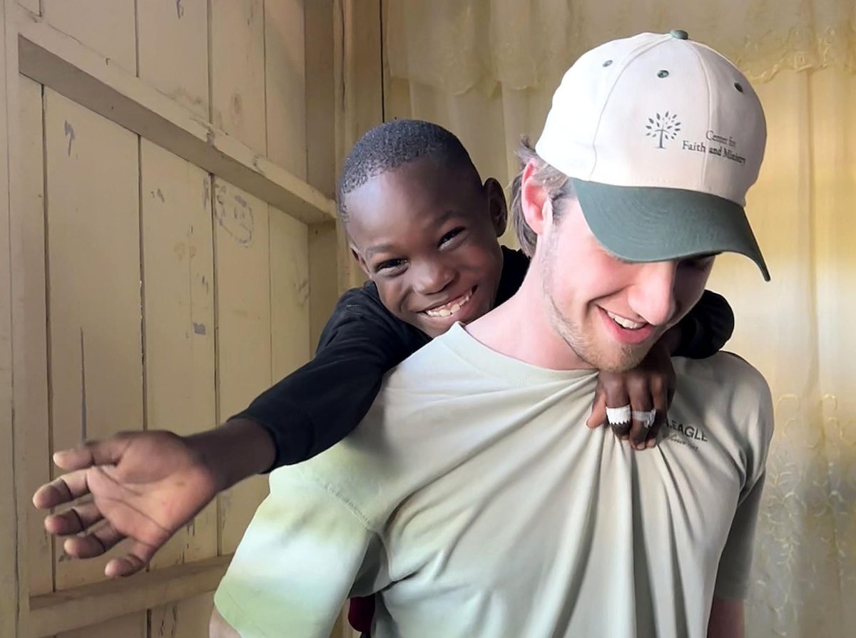 Sawyer Hess shares a special moment with one of the children during the mission trip.